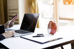hands holding credit card using laptop online shopping